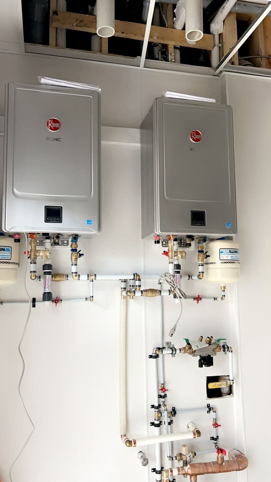 Grandmark mechanical installation with two wall-mounted units, valves and piping